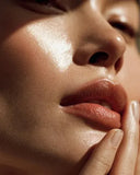 Close-up of a person's face with a focus on the glowy skin and texture