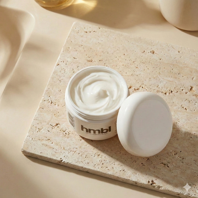 open jar of hmbl rich cream skincare on a stone counter