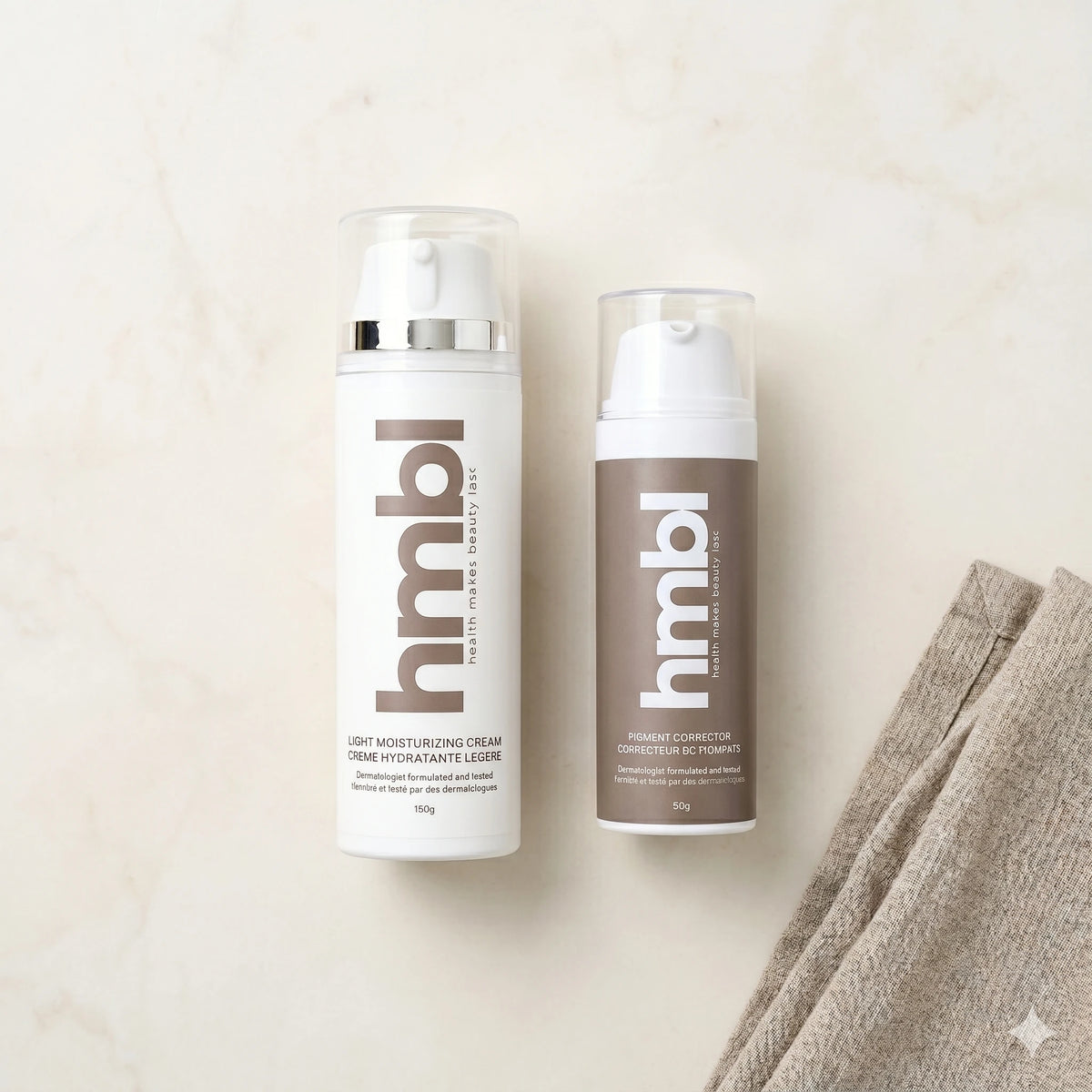 hmbl light moisturizer and hmbl pigment corrector on clean counter with towel 