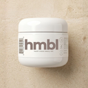 A white cosmetic jar with a matching lid featuring hmbl health makes beauty last rich cream moisturizer