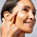 Woman applying Vivier Illuminating Enzymatic Peel to her face