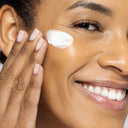 Woman applying vivier hydrating face mask to her face with a close-up view.